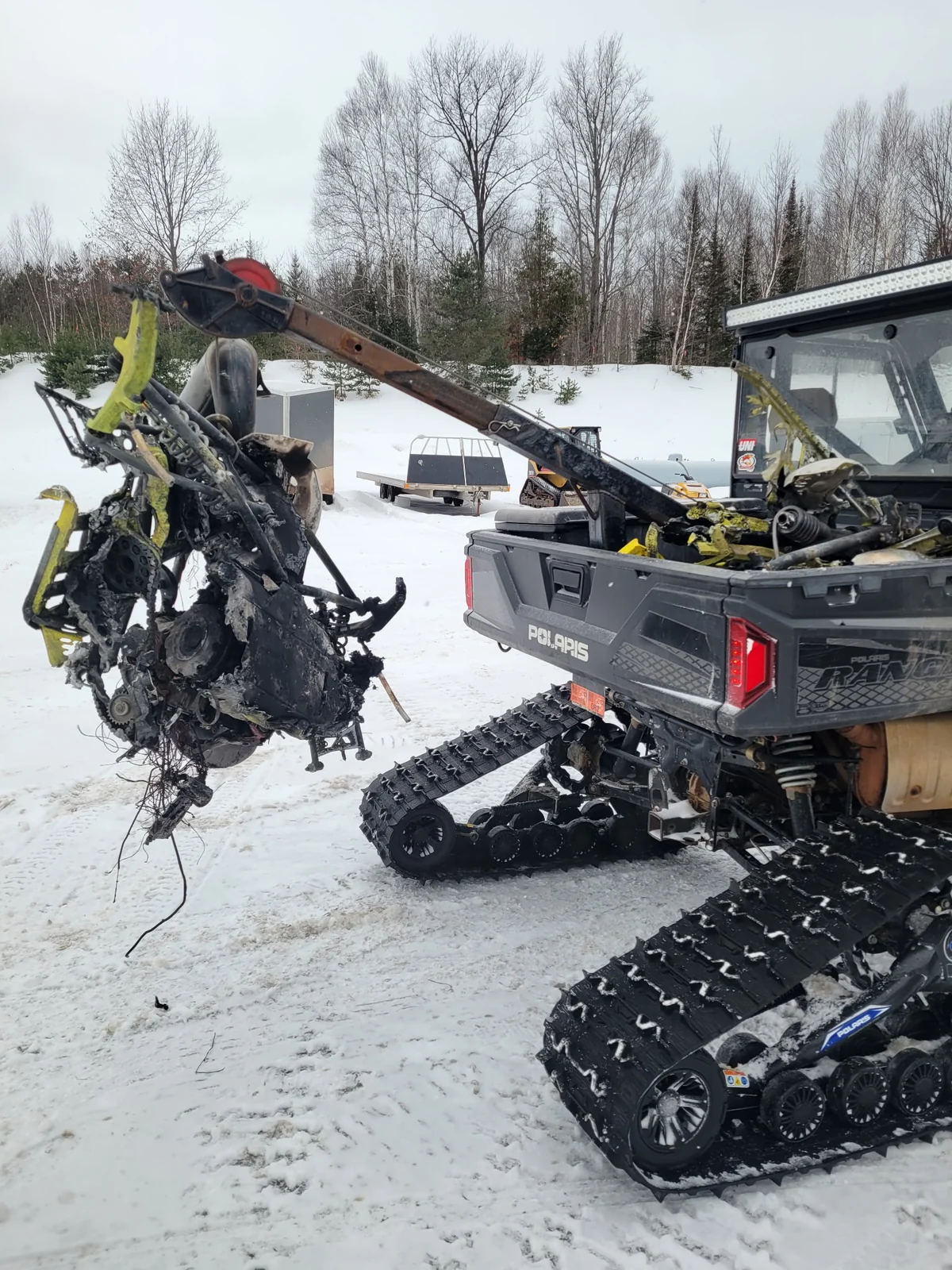 Dishaw Towing recovering damaged off-road equipment in winter