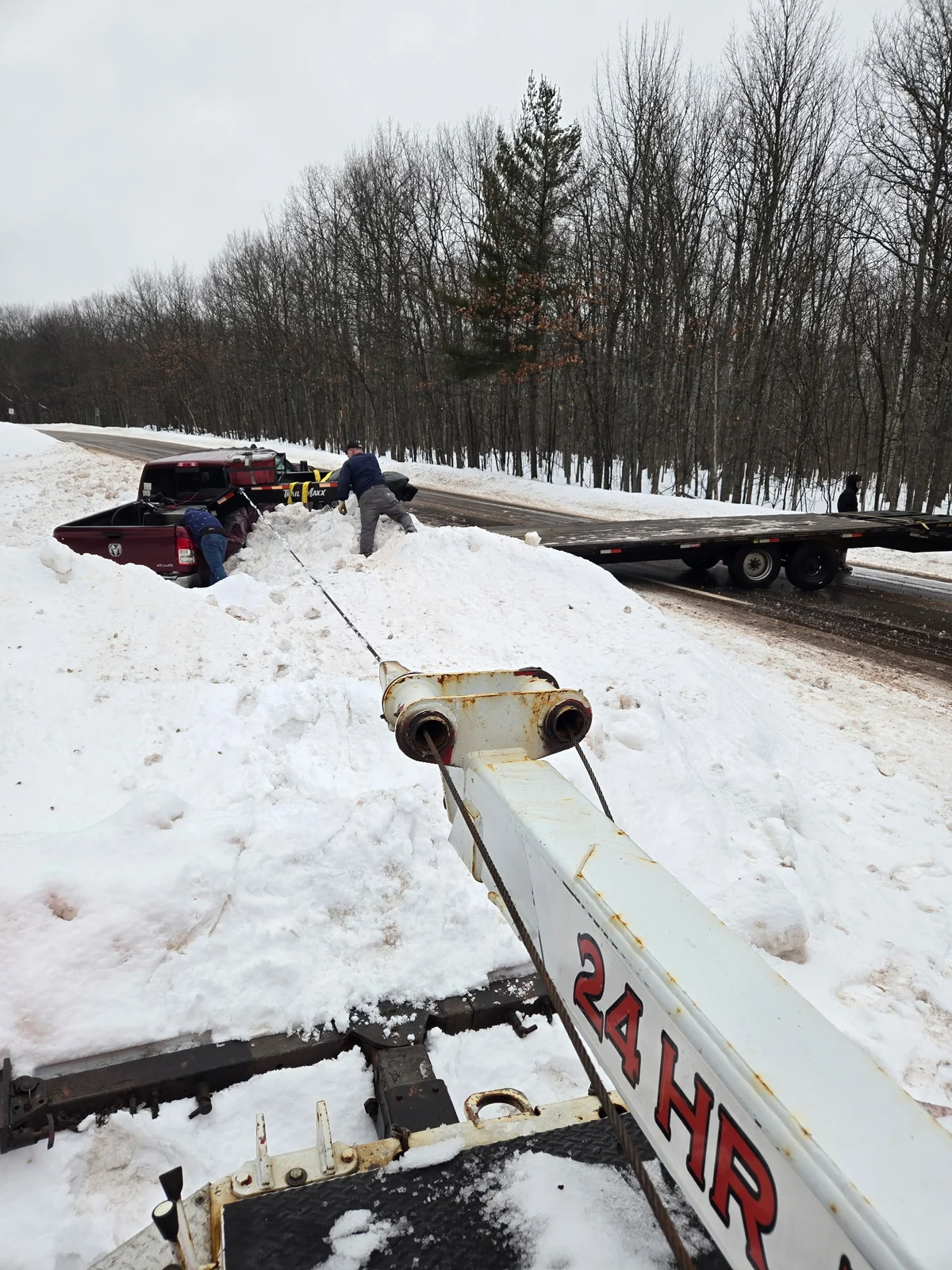 Dishaw Towing winching a vehicle from deep snow